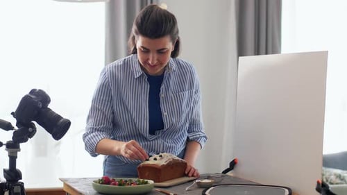 Woman Decorating Cake with Fresh Berries at Home