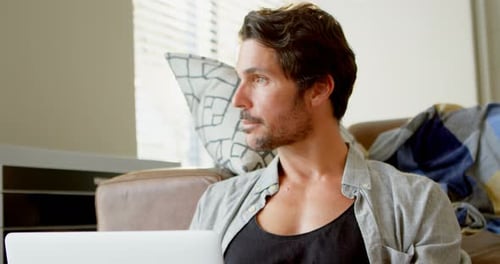 Man Using Laptop in Living Room 4k