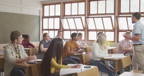 Teacher speaking to students in high school class