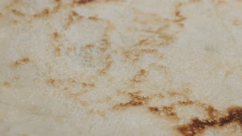 Texture of pancake after being fried close-up 4K 2160p 30fps UltraHD tilting footage - Slow tilt o