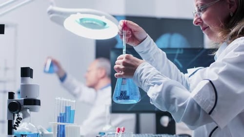 Woman Scientist Working in a Brightly Lit Laboratory