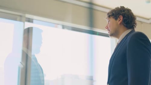 Businessmen Shaking Hands in Bright Modern Office