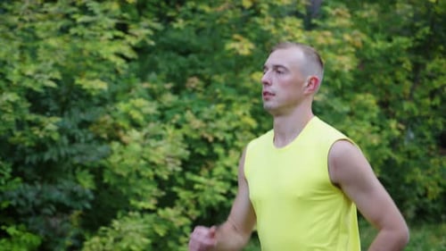Man Jogging in Forest in Slow Motion