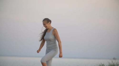 Woman Exercising at the Beach Outdoors in Daytime