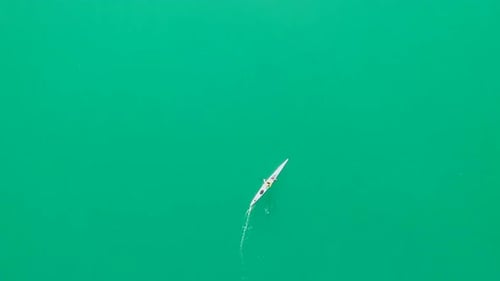 A kayaker paddles in a scenic mountain lake.