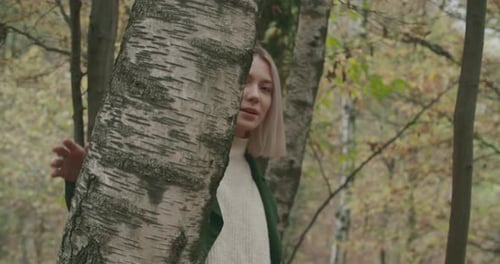 Woman Walking Through Forest in Autumn