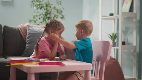 Boy and Girl Crafting Together at a Table