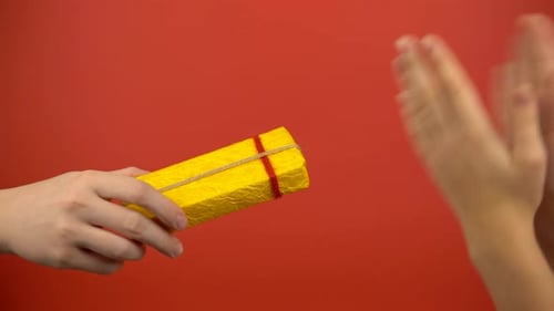 Giving a Wrapped Gift on Red Background