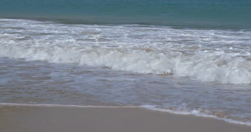 Sandy beach with water wave