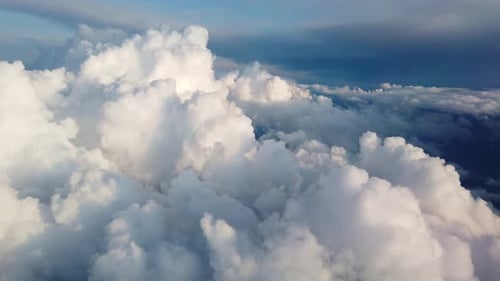 Beautiful Clouds Illuminated By Soft Sunlight Floating Above Land and Forming Layers.