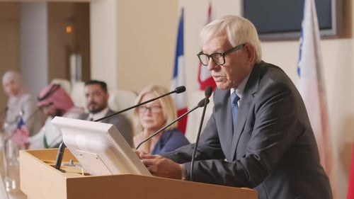 Man Giving Speech at a Podium During Conference