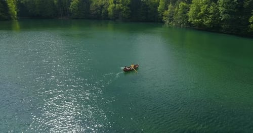 Young Couple In A Boat On The Background Of A Lake