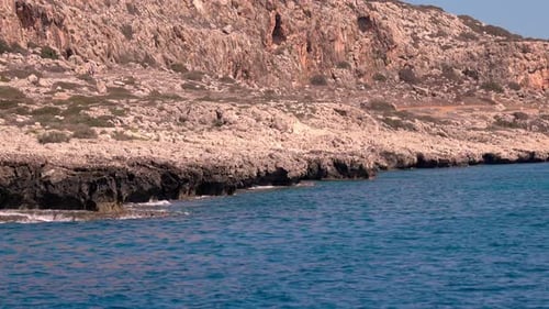 beautiful rugged coastline with waves crashing against the cliffs