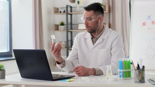 Man Conducting Remote Science Experiment at Desk