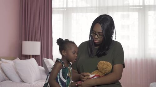 Loving Mother Hugs Child in Bedroom