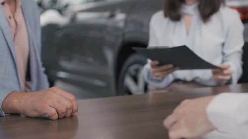 People Closing Deal in Dealership