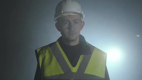 Construction Worker with Safety Vest and Hardhat at Night