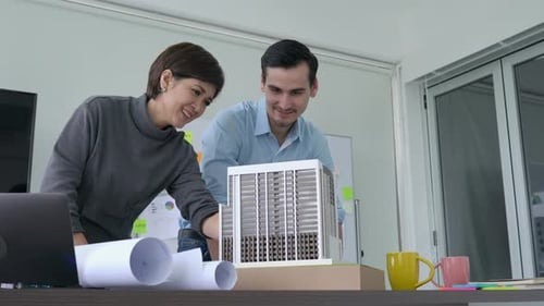 Business person working with building model