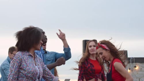 Friends Dancing at a Rooftop Party Celebration