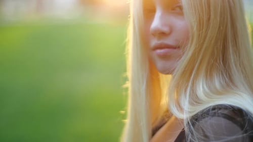 Blonde Woman Bathed in Golden Sunlight, Close Up