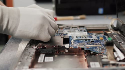 Laptop Repair Technician Working on Circuit Board