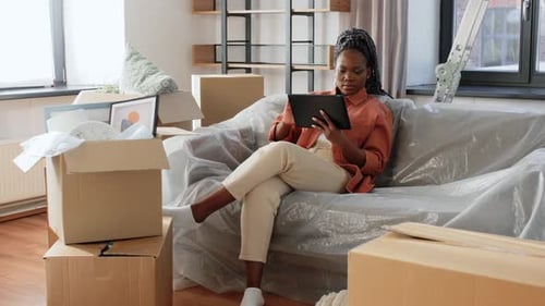Young Woman Using Tablet in New Home