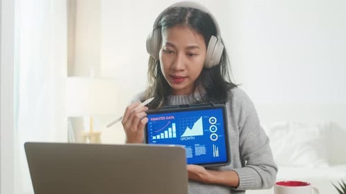 Woman Presents Business Data via Tablet at Home