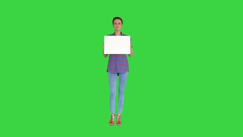 Attractive Woman Shows Blank White Poster on a Green Screen, Chroma Key