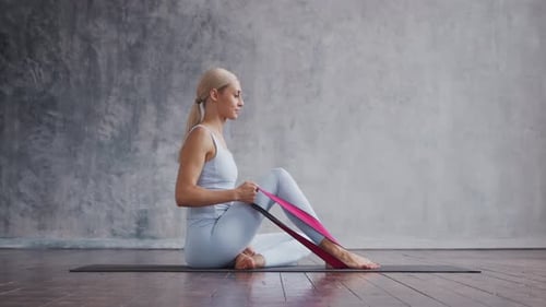 Young Adult Woman Working out With Resistance Band