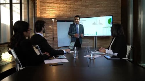 Business Team Attends Presentation in Modern Office