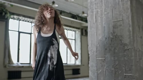 Energetic Woman Dancing in an Urban Loft