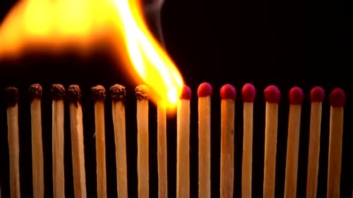 Matches Burning in a Row on Black Background