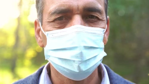 Mature Man in Mask in Park