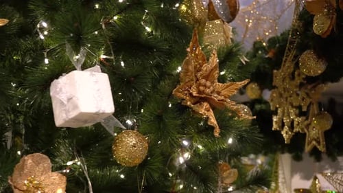 Christmas Tree Decorated with Gold and White Ornaments