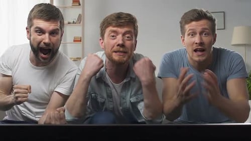 Friends Watching TV with Excitement at Home