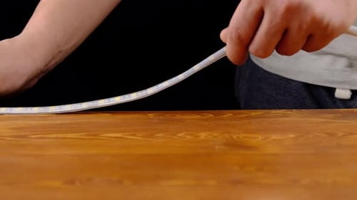 Hands Placing a White LED Strip Light