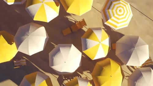 Vacations and travel concept. Yellow sun umbrellas and lounge chairs on a beach.