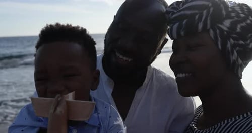 African parents and little son having fun on the beach - Family people and love concept