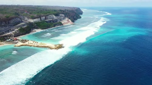 Aerial drone shot panorama of relaxing island beach wildlife by blue water with white sandy backgrou