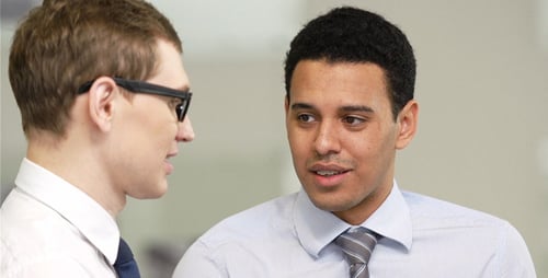 Two Businessmen Talking in Bright Corporate Office
