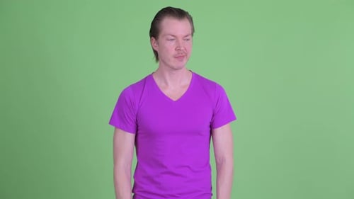 Young Adult Man Gives Thumbs Down and Shrugs