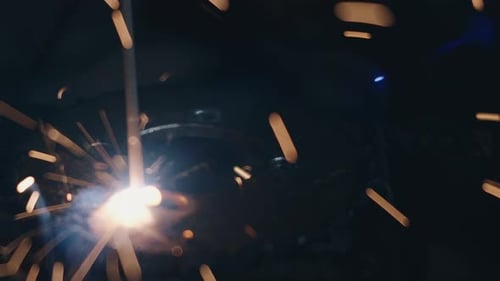 Close Up of Intense Welding Sparks in the Dark