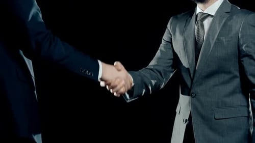 Businessmen Shaking Hands Deal on Black Background