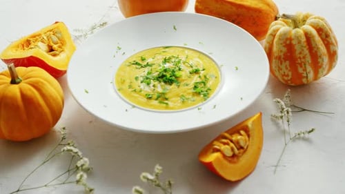 Soup in Plate with Pumpkins Around