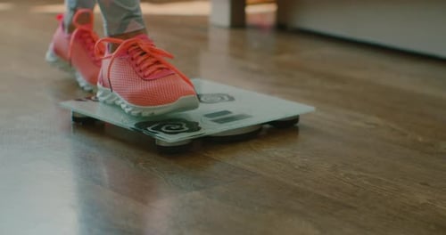Person Weighing Themselves on Bathroom Scale