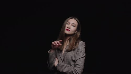 Stylish Woman Posing Confidently Against Black Background