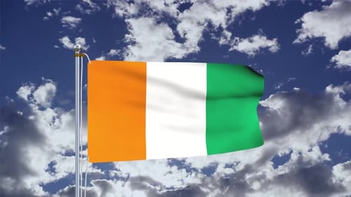 Waving Flag of Côte d'Ivoire Against Blue Sky