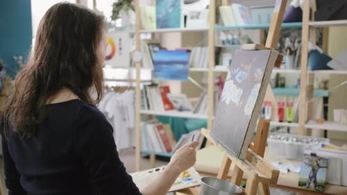 Woman Painting Art in Bright Studio