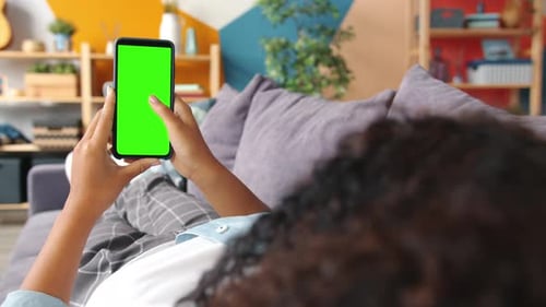 Slow Motion of Female Hand Holding Smartphone with Chroma Key Green Screen Swiping