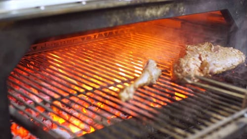 Chef Prepares Bone Steak. Cooking Process on Barbecue Restaurant Kitchen